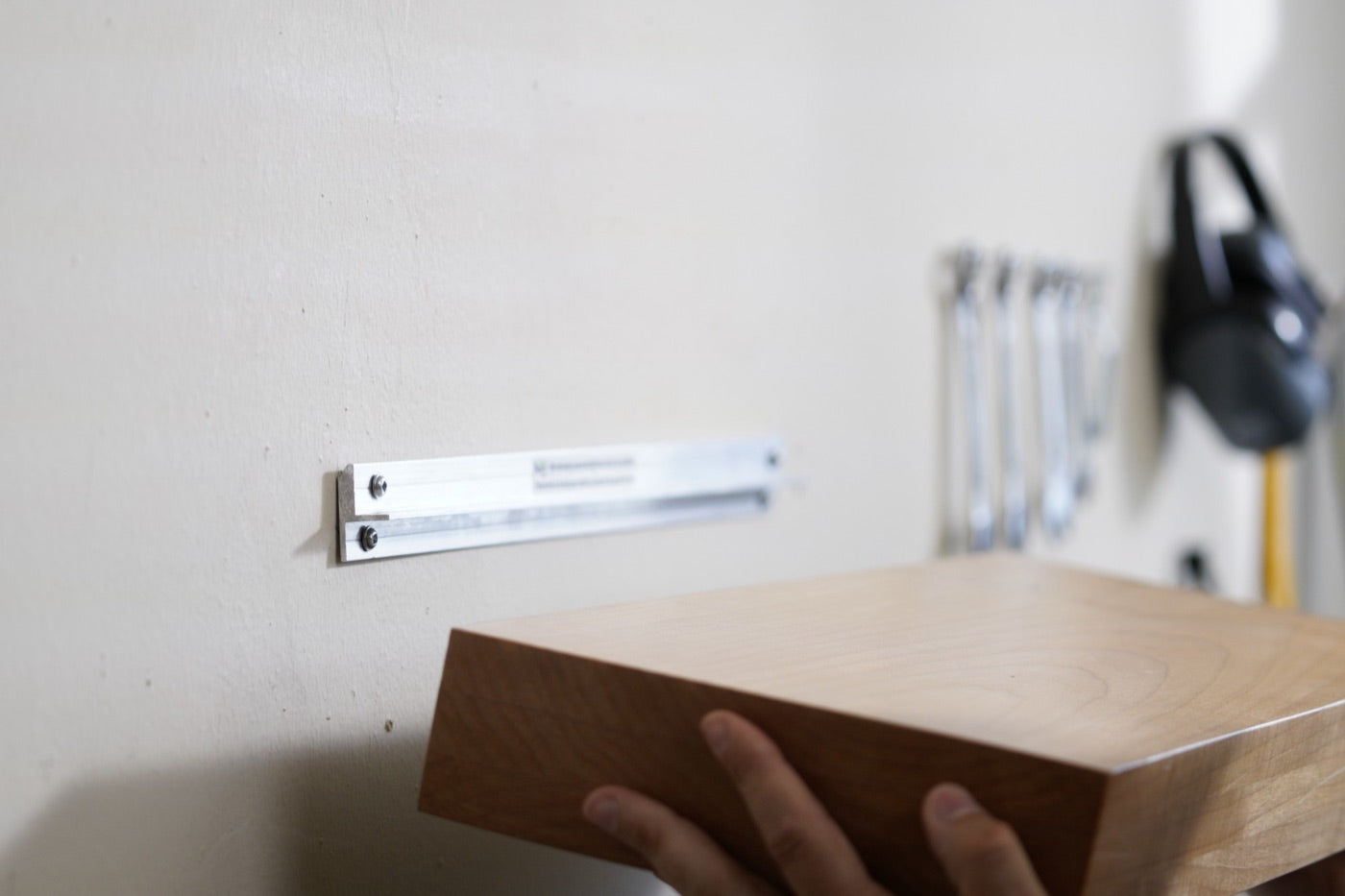 Wall bracket screwed to the wall with the shelf ready to slide on